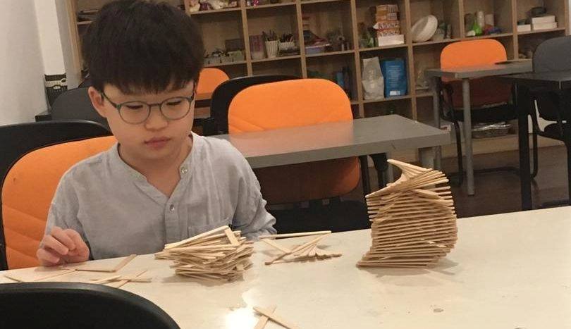 Boy concentrating on a hand-built model